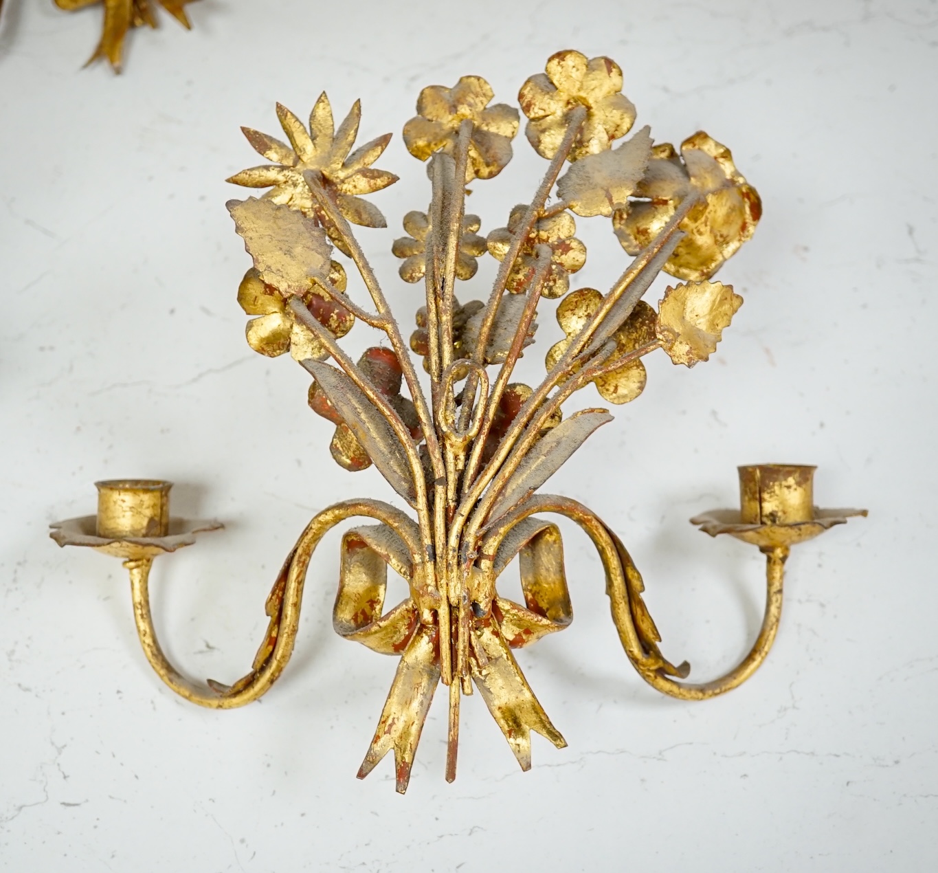 A set of four gilt metal two branch wall sconces, largest 26cm high. Condition - fair